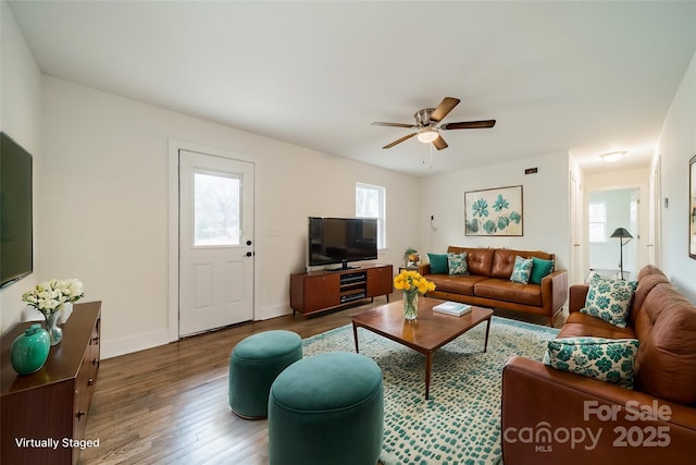 living room featuring hardwood / wood-style flooring and ceiling fan