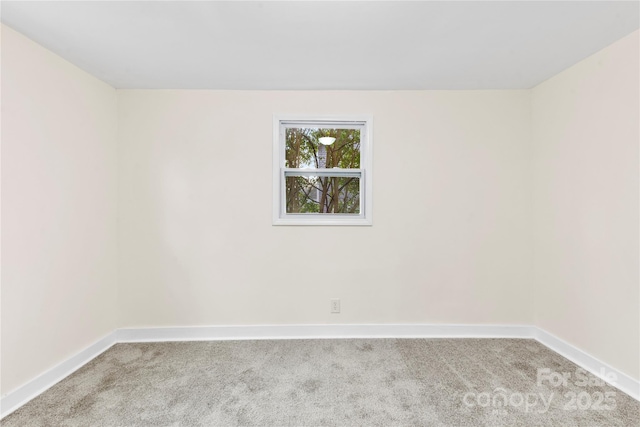 unfurnished room featuring light colored carpet