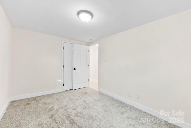 spare room with light colored carpet