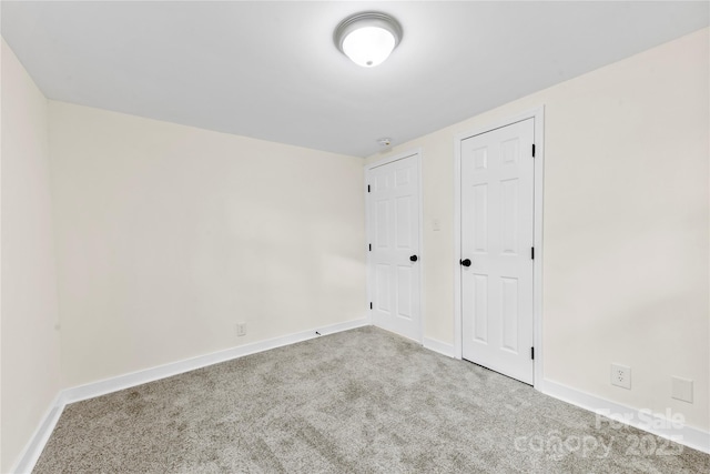 spare room featuring light colored carpet