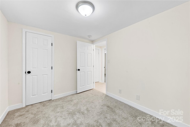 unfurnished bedroom featuring light colored carpet