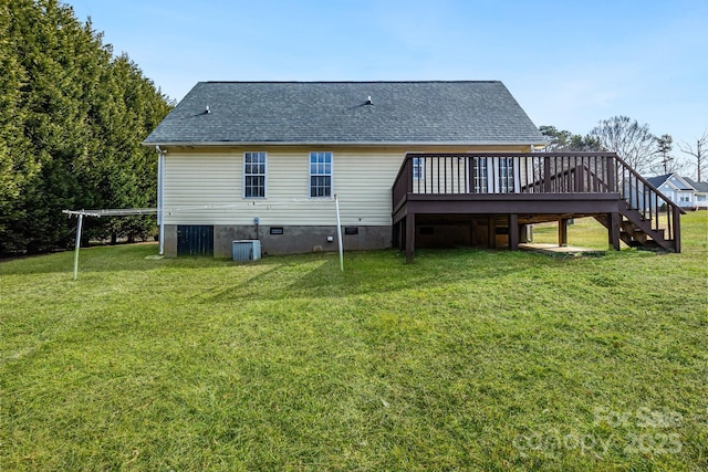 rear view of property featuring cooling unit, a wooden deck, and a lawn