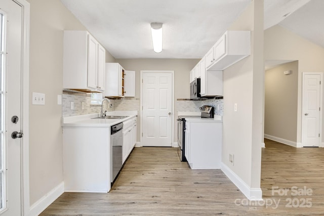 kitchen featuring white cabinetry, stainless steel appliances, sink, and light hardwood / wood-style flooring