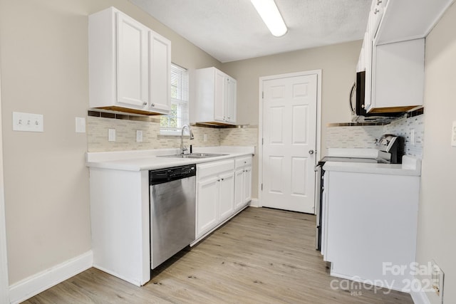 kitchen with sink, white cabinetry, a textured ceiling, light wood-type flooring, and stainless steel appliances