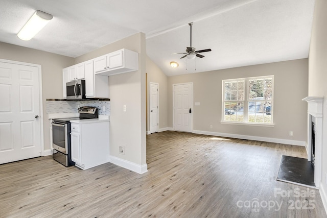 kitchen with decorative backsplash, light hardwood / wood-style flooring, stainless steel appliances, and white cabinets