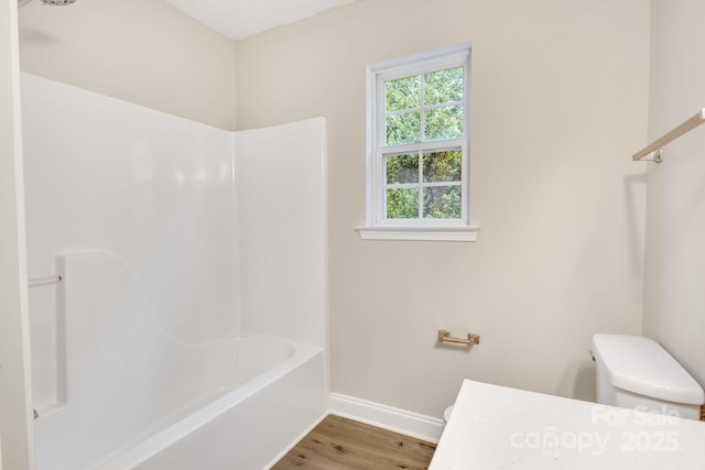 bathroom with hardwood / wood-style floors and toilet