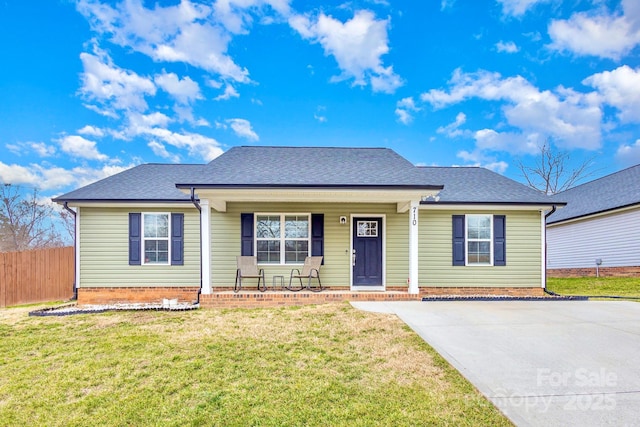 ranch-style home with covered porch and a front lawn