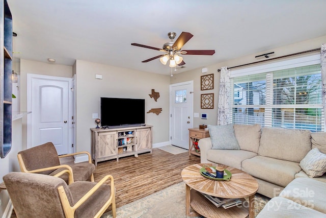 living room featuring hardwood / wood-style flooring and ceiling fan