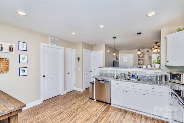 kitchen with range with electric stovetop, dishwasher, sink, white cabinets, and hanging light fixtures