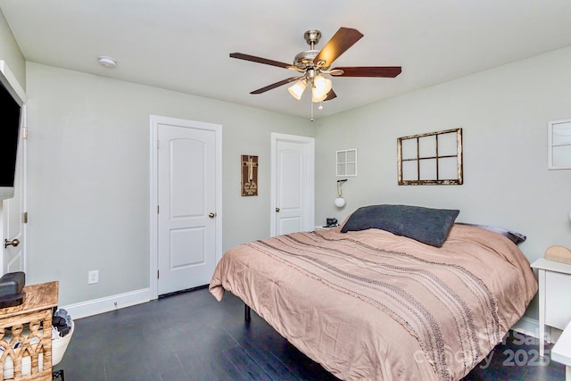 bedroom with dark hardwood / wood-style floors and ceiling fan