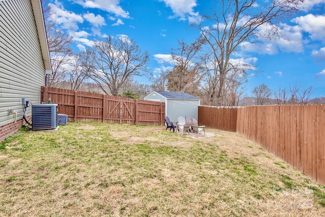 view of yard featuring an outdoor fire pit, a shed, and central air condition unit