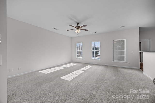 carpeted empty room featuring ceiling fan