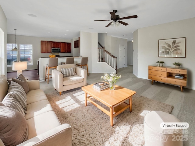 living room featuring ceiling fan and light carpet