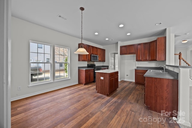 kitchen with dark wood-type flooring, sink, decorative light fixtures, a center island, and electric range