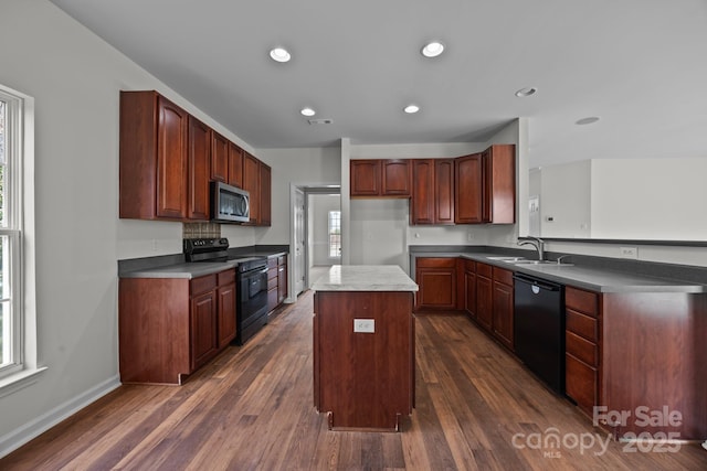 kitchen featuring sink, black appliances, dark hardwood / wood-style floors, and a kitchen island