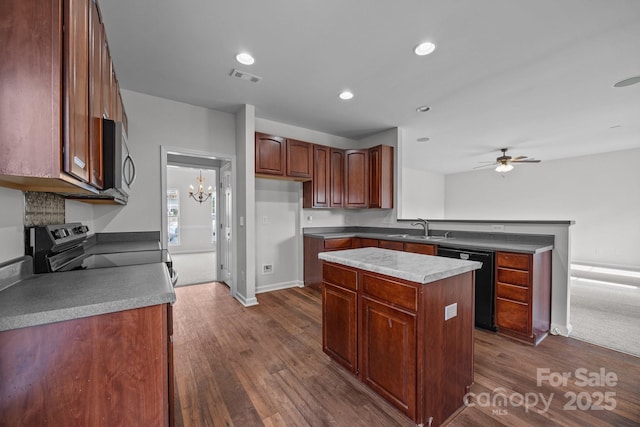 kitchen with stainless steel appliances, a kitchen island, sink, and dark hardwood / wood-style floors