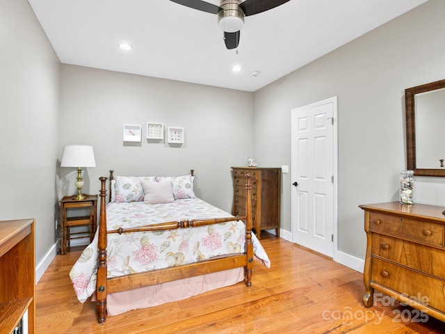 bedroom with ceiling fan and light hardwood / wood-style flooring