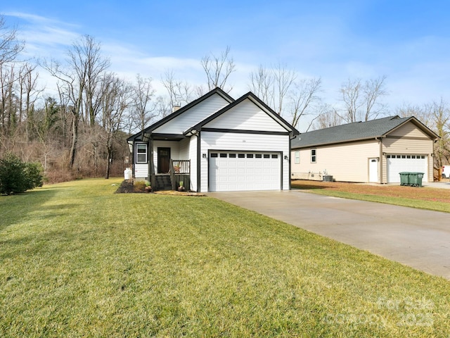 view of front of house featuring a garage, covered porch, and a front yard