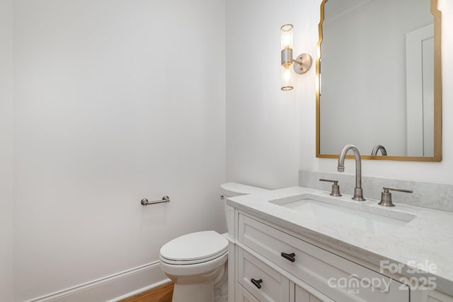 bathroom featuring hardwood / wood-style flooring, vanity, and toilet