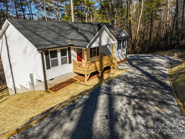 view of front of home featuring crawl space, a wooden deck, and a shingled roof