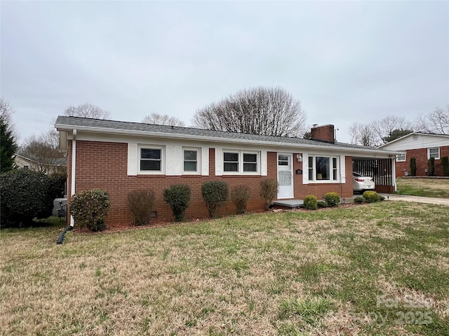 ranch-style home with brick siding, a chimney, an attached carport, crawl space, and a front yard