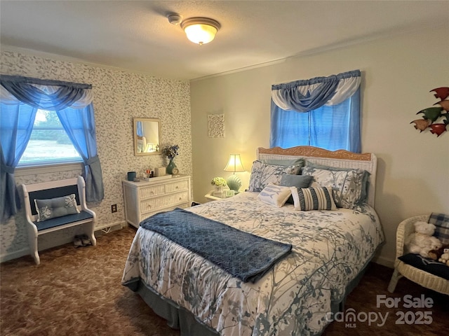 bedroom with wallpapered walls, carpet, and baseboards