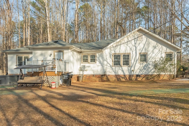 single story home with a hot tub, a front yard, and a deck