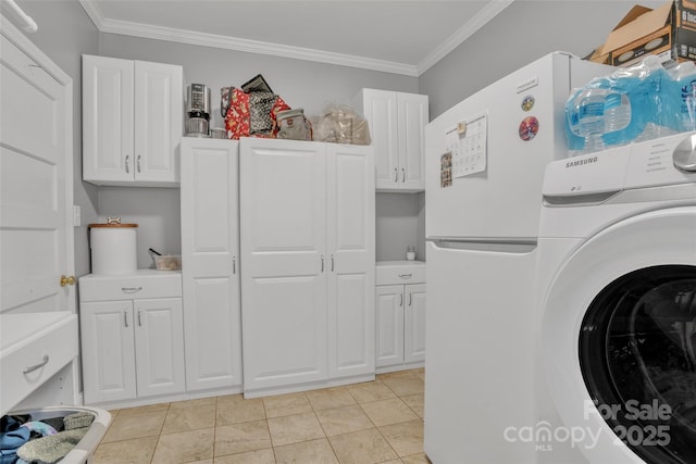 laundry area featuring cabinets, crown molding, light tile patterned flooring, and washer / clothes dryer