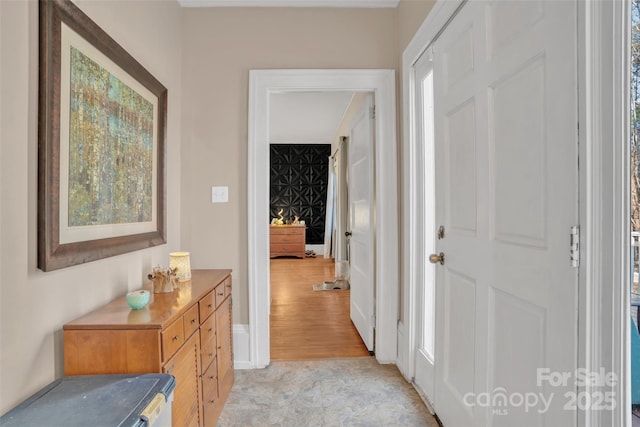 corridor with light hardwood / wood-style floors