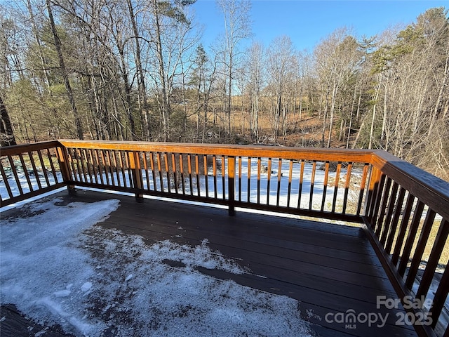 deck featuring a water view and a view of trees