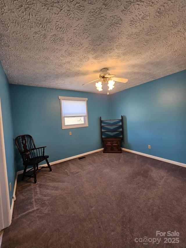 unfurnished room with ceiling fan, a textured ceiling, carpet flooring, and baseboards