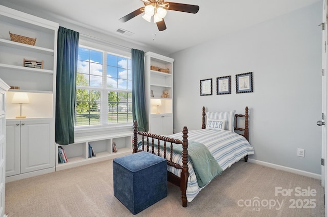carpeted bedroom featuring ceiling fan, visible vents, baseboards, and multiple windows