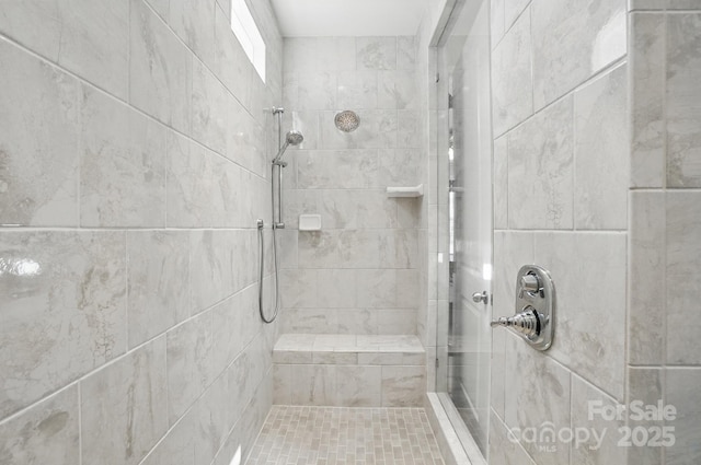 bathroom with tiled shower