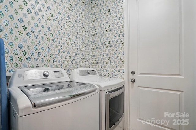 washroom with washer and clothes dryer and laundry area