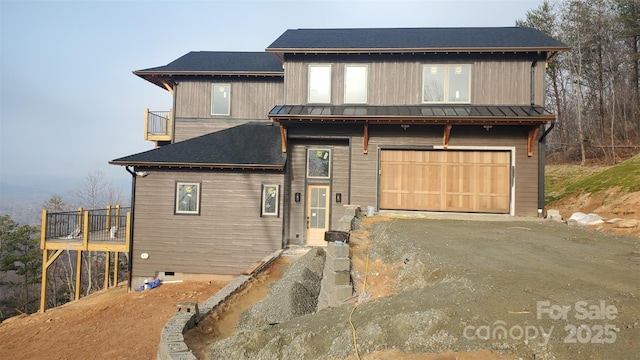 view of front of home with a balcony and a garage