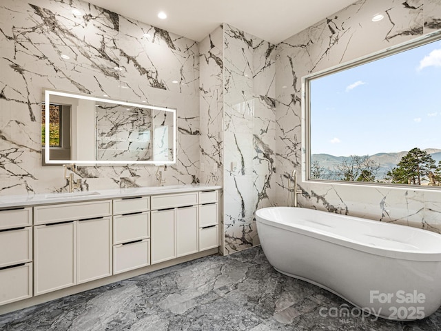 246 Half Moon Mile, Lake Lure, NC 28746 - bathroom featuring stone wall, marble tiled floors, double vanity, healthy amount of natural light, and recessed lighting