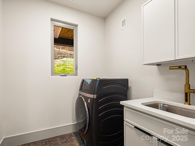 246 Half Moon Mile, Lake Lure, NC 28746 - laundry area with cabinet space, washer / dryer, baseboards, and dark stone finish flooring