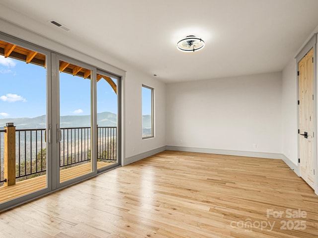 246 Half Moon Mile, Lake Lure, NC 28746 - empty room with light wood-style floors, baseboards, and a mountain view