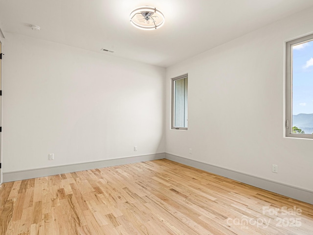 246 Half Moon Mile, Lake Lure, NC 28746 - unfurnished room featuring wood finished floors, baseboards, and a smoke detector