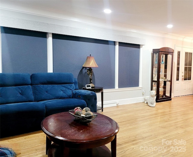 living room with hardwood / wood-style flooring and ornamental molding