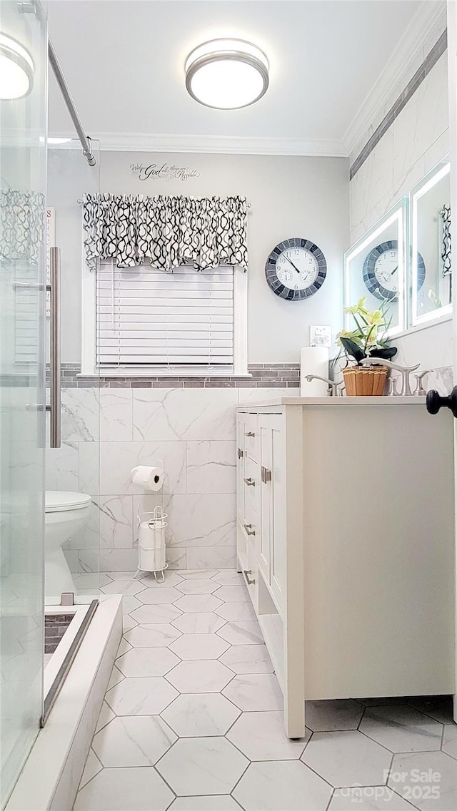 bathroom with crown molding, toilet, tile walls, and a shower