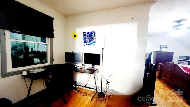 home office with wood-type flooring