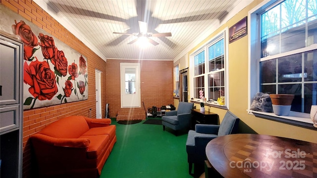 sitting room with crown molding, plenty of natural light, and ceiling fan