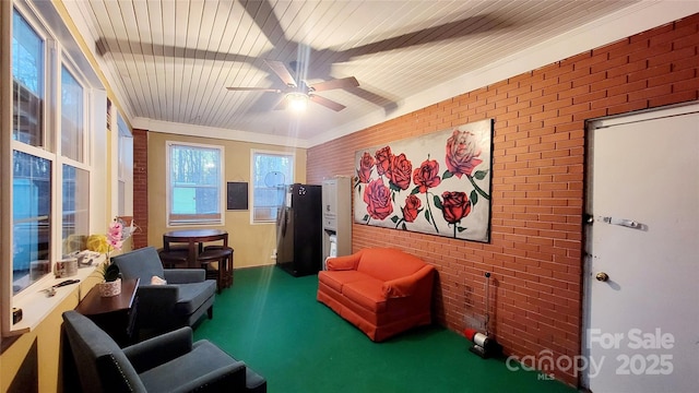 living area with crown molding, ceiling fan, brick wall, and wooden ceiling