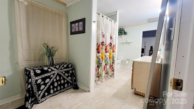 bathroom featuring crown molding, vanity, and toilet