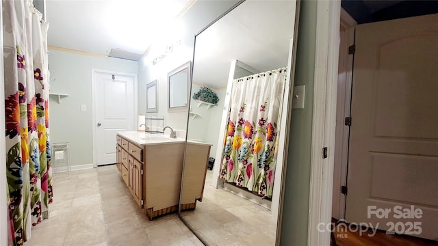 bathroom featuring crown molding and vanity