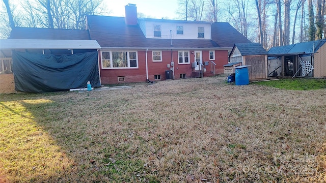 rear view of property with central AC unit and a lawn