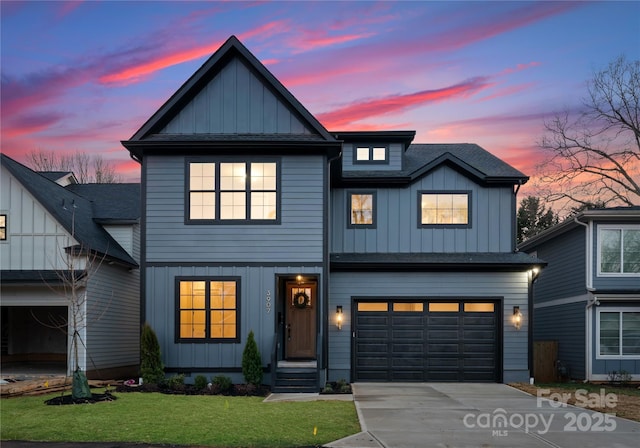 modern inspired farmhouse with a shingled roof, concrete driveway, board and batten siding, a front yard, and a garage