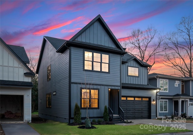 view of front of property with board and batten siding, driveway, and a garage