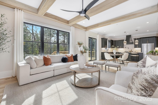 living area with recessed lighting, light wood-style floors, a ceiling fan, beamed ceiling, and baseboards